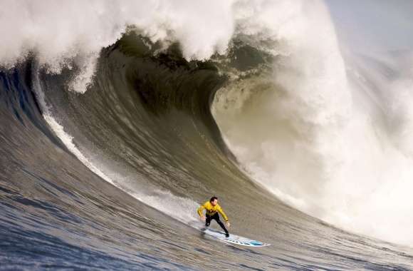 A Surfer Rides Down A Wave