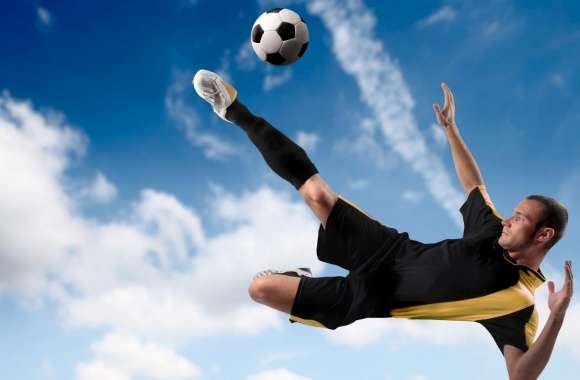 Football Player Kicking The Ball in Mid Air