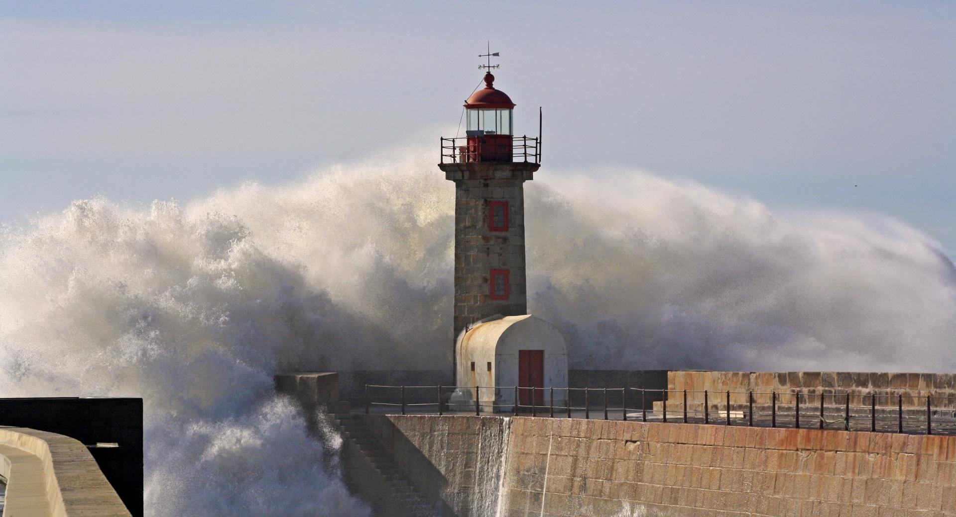 A Huge Wave Crashing Over A Lighthouse wallpapers HD quality