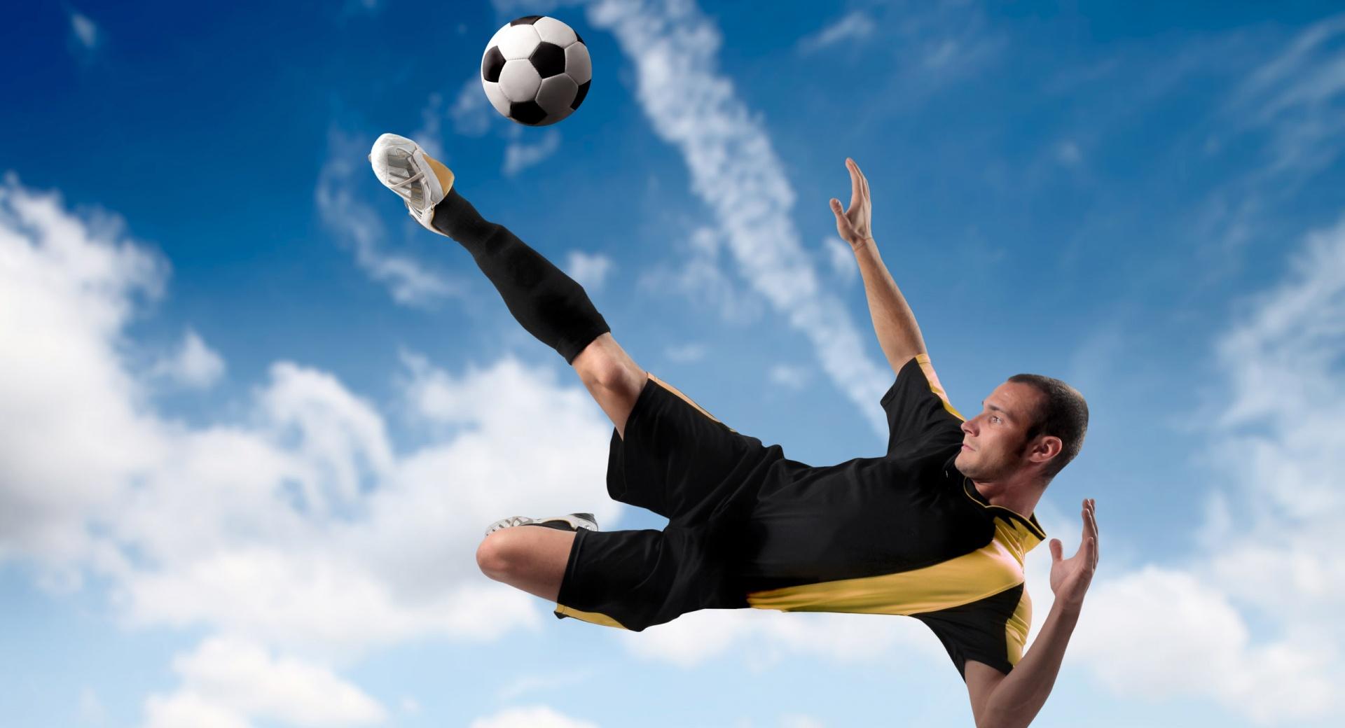Football Player Kicking The Ball in Mid Air at 2048 x 2048 iPad size wallpapers HD quality