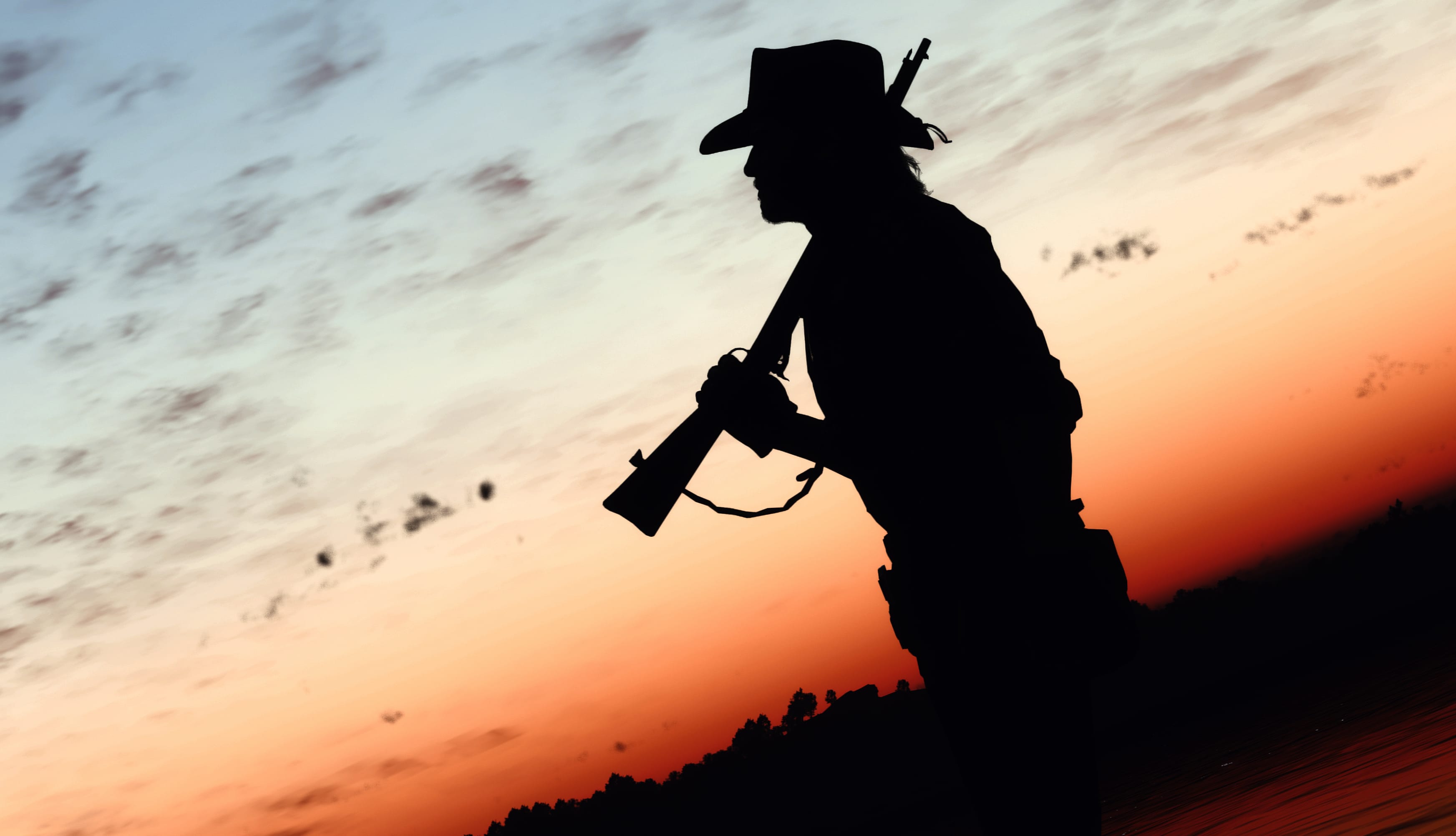 Red Dead Redemption-Inspired Cowboy Silhouette at Sunset wallpapers HD quality