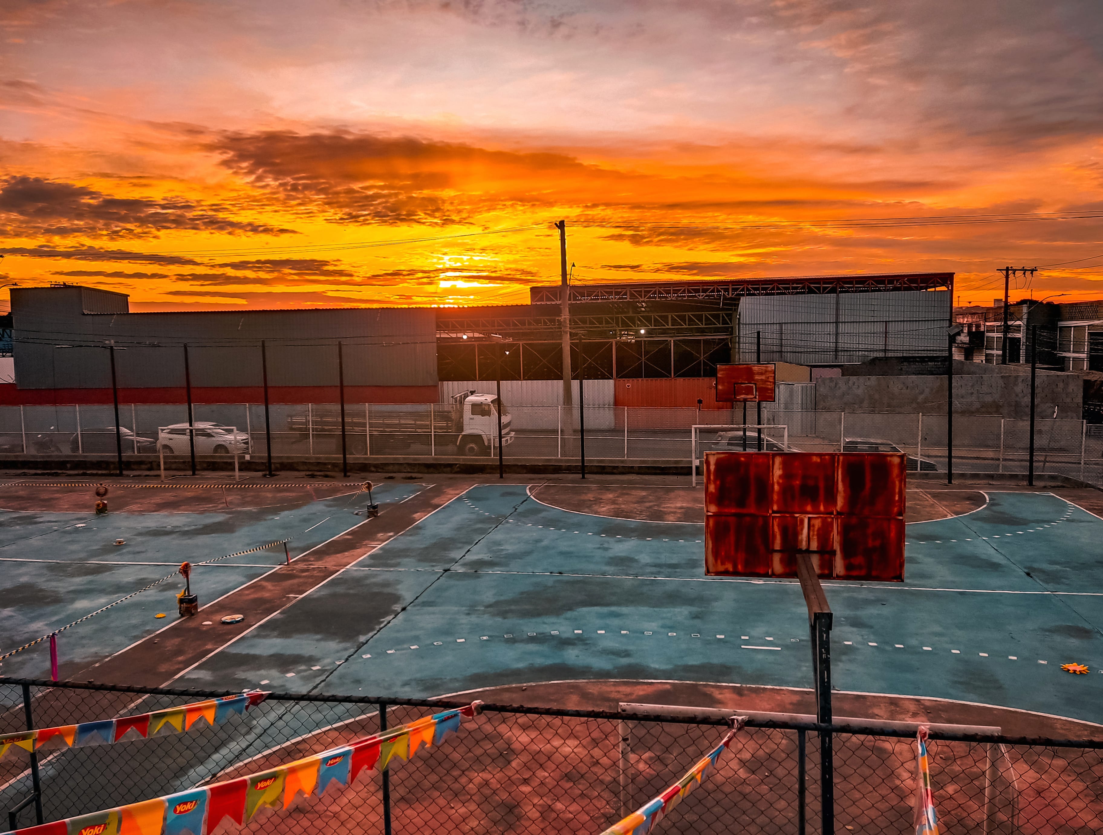 A basketball court with a sunrise in the background wallpapers HD quality