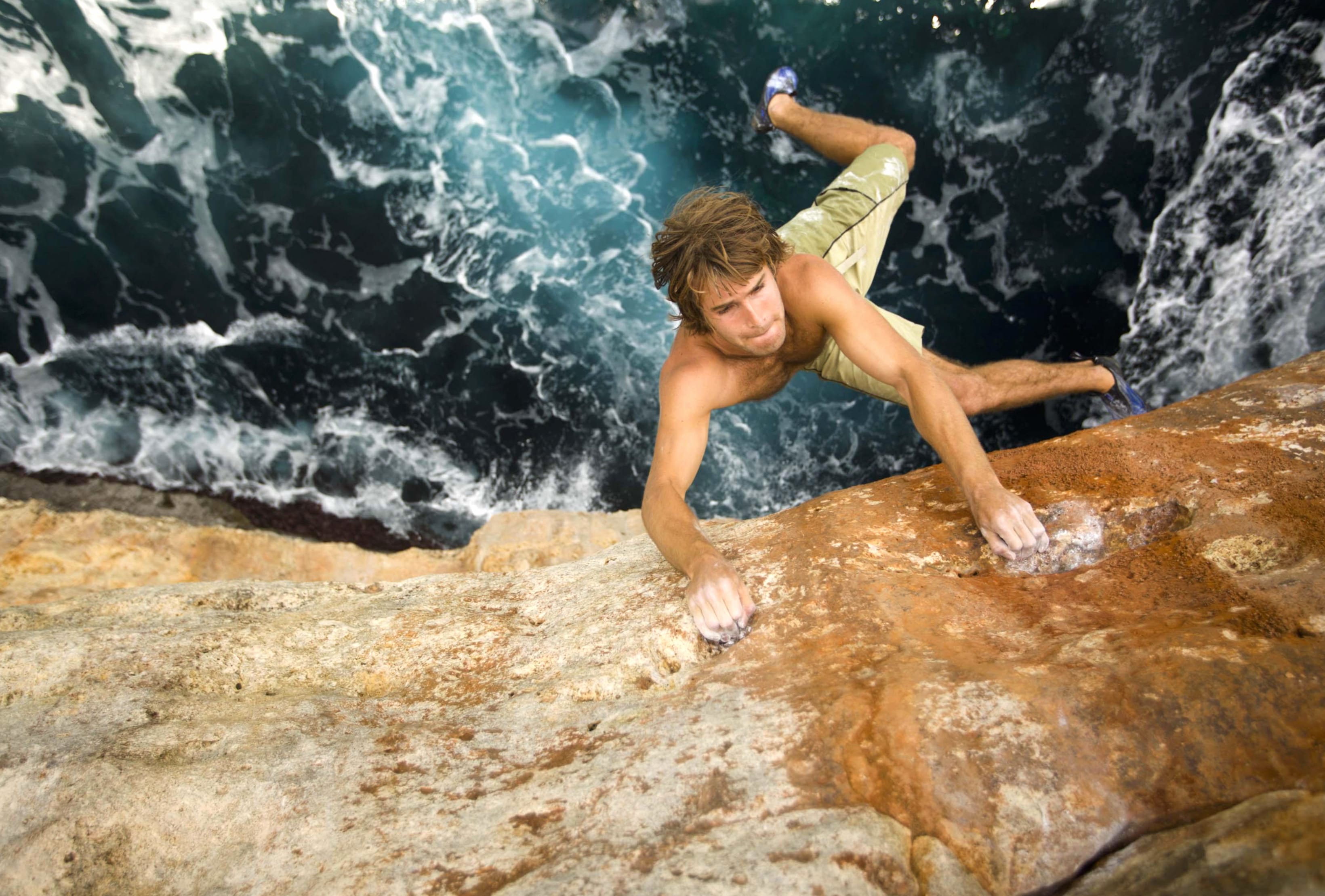 Epic Rock Climbing Adventure Over Ocean Waves wallpapers HD quality