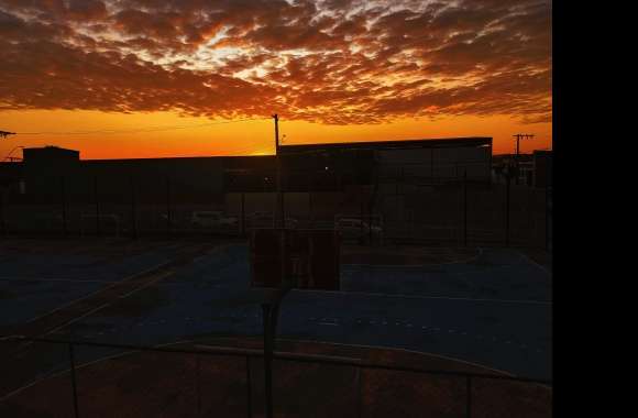 A basketball court with a sunset in the background wallpapers hd quality