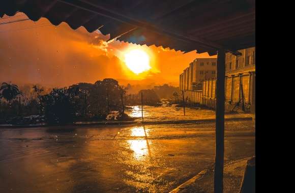 A sun setting over a road