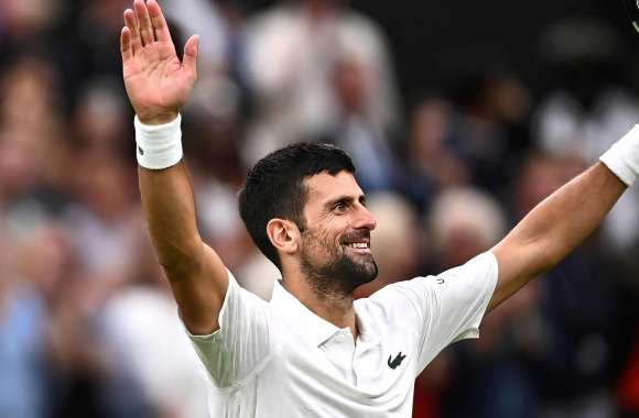 Novak Djokovic celebrates after notching his 34th consecutive Wimbledon win