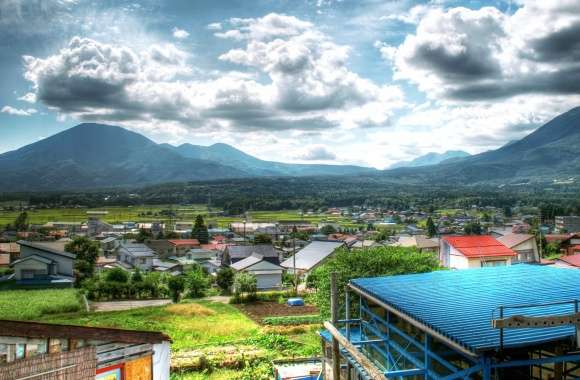 Sunny Village Landscape Mountains, Clouds, and Community Charm